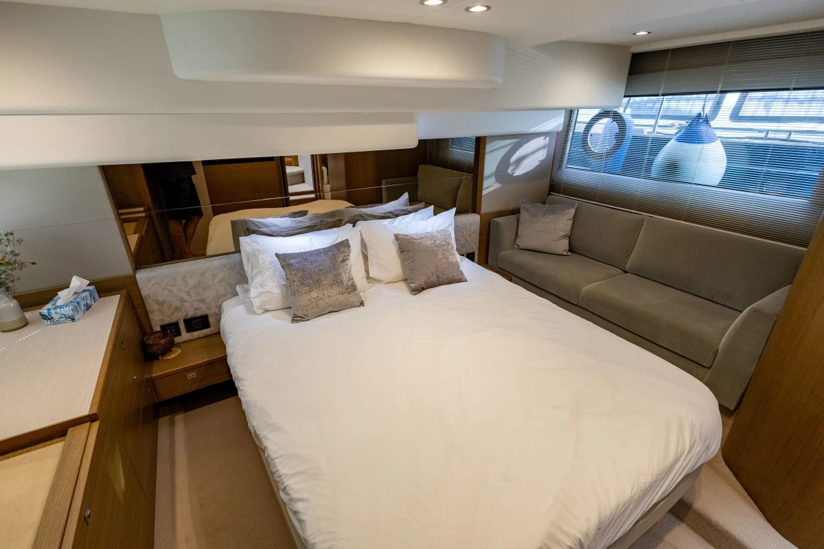 Luxurious bedroom interior of 2018 Princess 49 yacht with elegant furnishings and soft lighting.