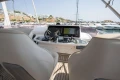 Helm of 2018 Princess 49 yacht with navigation equipment in marina setting.