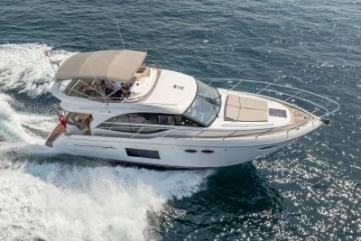 Luxurious 2018 Princess 49 yacht cruising on open sea, showcasing elegant design.