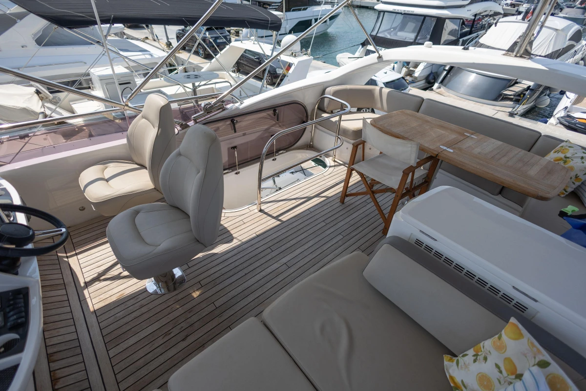 Luxurious 2018 Princess 49 yacht deck with seating and dining area.