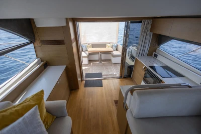 Luxurious interior of 2018 Princess 49 yacht with modern kitchen and seating area.