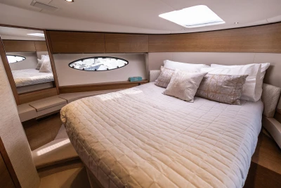 Luxurious cabin interior of 2018 Princess 49 yacht with elegant bedding and modern design.