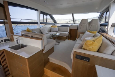 Luxurious interior of 2018 Princess 49 yacht with elegant seating and panoramic windows.
