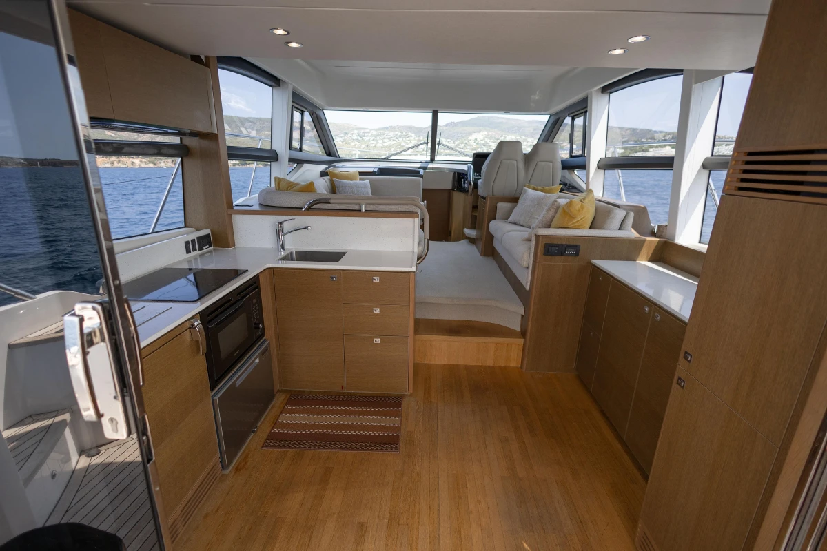 Luxurious interior of 2018 Princess 49 yacht with modern kitchen and seating area.