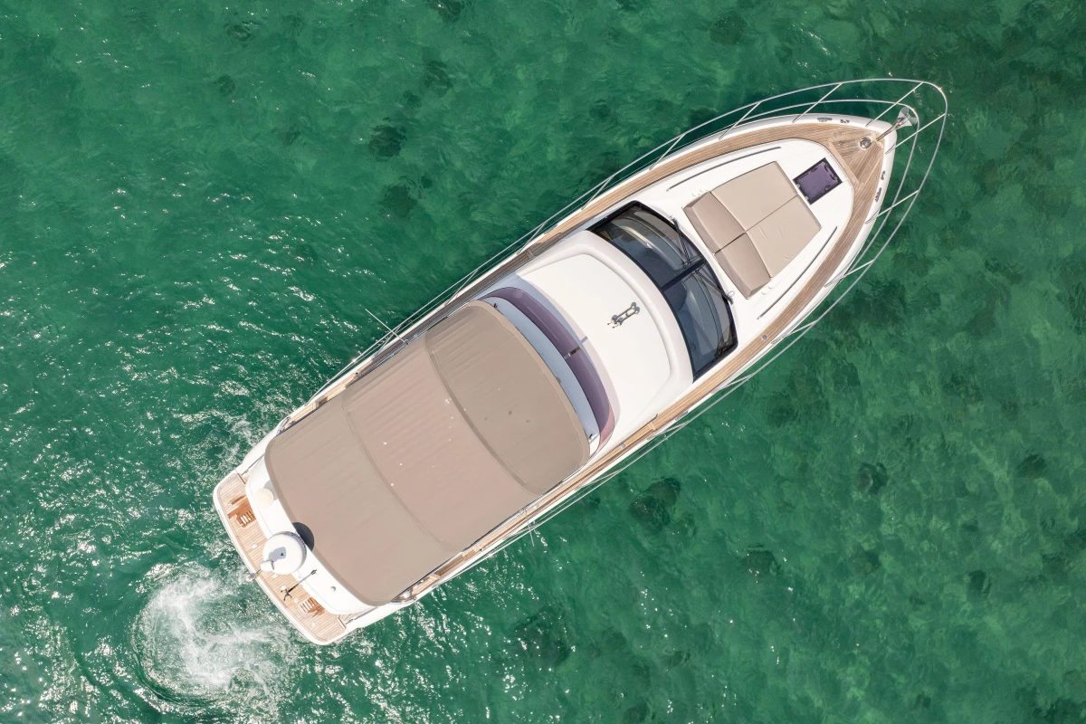 Aerial view of 2018 Princess 49 yacht cruising in clear turquoise waters.