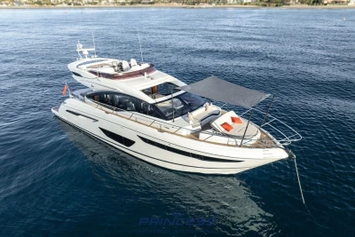 Luxurious 2019 Princess S60 yacht anchored on calm blue waters.
