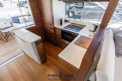 Luxurious 2019 Princess S60 yacht interior with modern kitchen and elegant wood finishes.