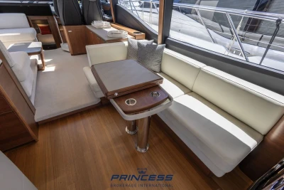 Luxurious interior of 2019 Princess S60 yacht with elegant seating and wooden table.