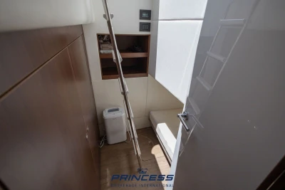 Interior of 2019 Princess S60 yacht with ladder, storage, and seating area.
