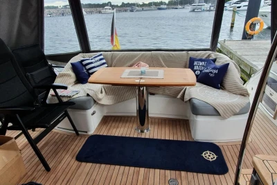 Cozy seating area on a 2017 Princess 43 yacht with nautical decor and waterfront view.
