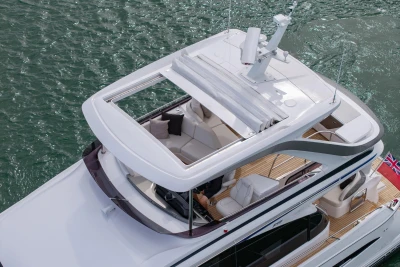 Aerial view of 2025 Princess F58 yacht with open sunroof on water.