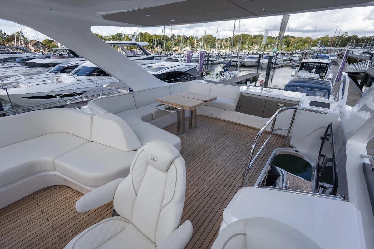 Luxurious 2025 Princess F58 yacht with spacious deck and elegant seating at marina.