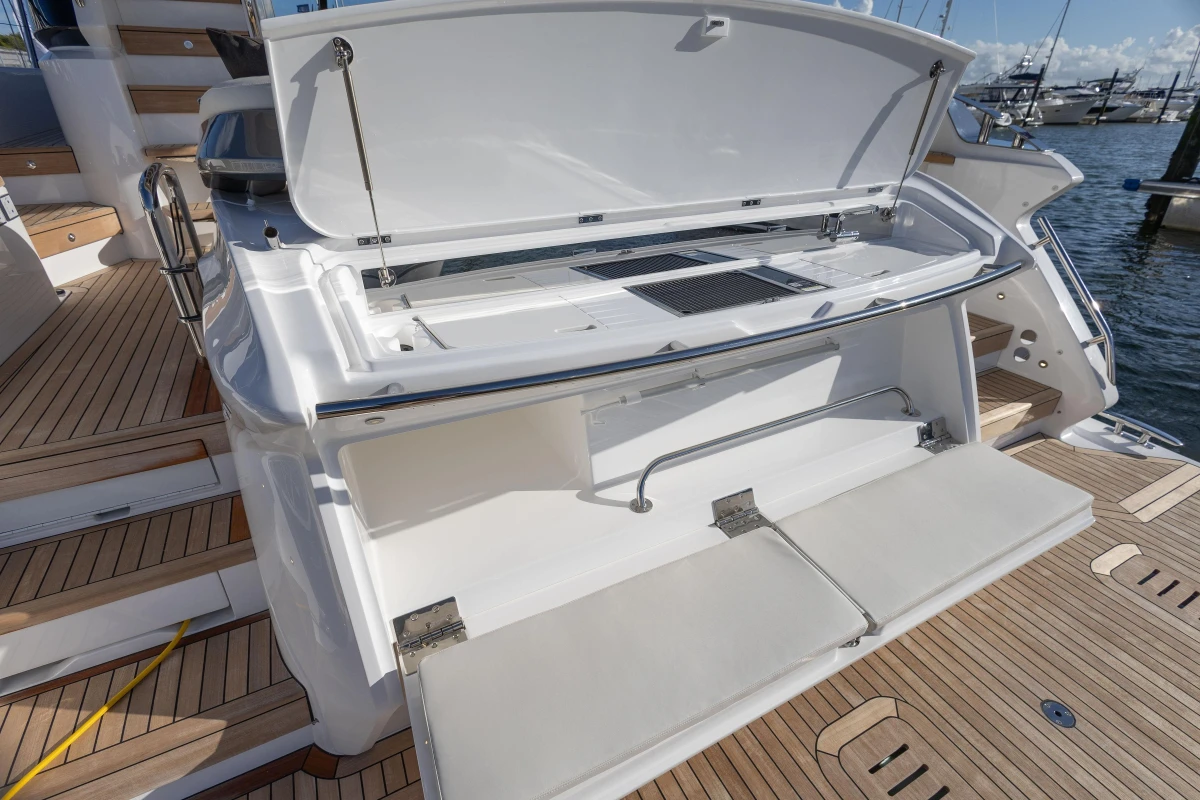 2025 Princess F58 yacht with open storage compartment on teak deck.