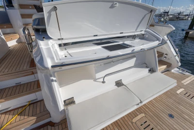 2025 Princess F58 yacht with open storage compartment on teak deck.