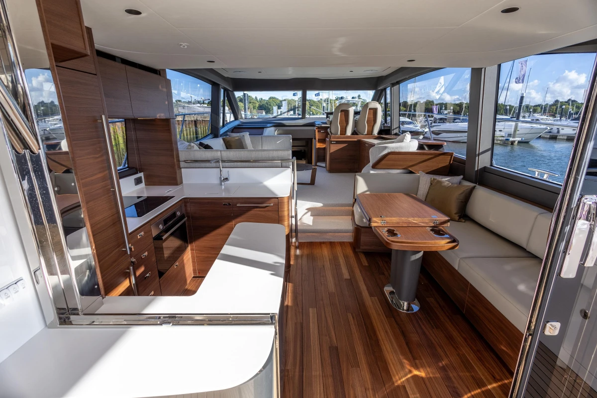 Luxurious interior of 2025 Princess F58 yacht with modern kitchen and seating area.