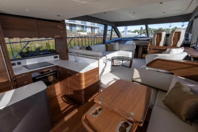 Luxurious interior of 2025 Princess F58 yacht with modern kitchen and seating area.