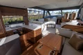Luxurious interior of 2025 Princess F58 yacht with modern kitchen and seating area.