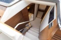 Luxurious interior of 2025 Princess F58 yacht, featuring elegant wooden staircase and modern design.