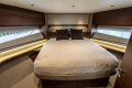 Luxurious 2025 Princess F58 yacht bedroom with elegant wood finishes and modern design.