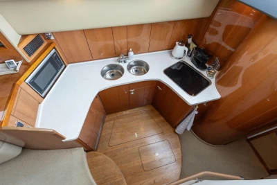 Luxurious kitchen area in a 2005 Princess 42 Flybridge Motor Yacht with modern amenities.
