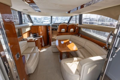 Luxurious interior of 2005 Princess 42 Flybridge Motor Yacht with elegant seating and wooden finishes.