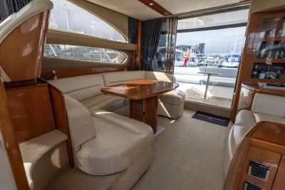 Luxurious interior of 2005 Princess 42 Flybridge Motor Yacht with elegant seating and wooden finishes.