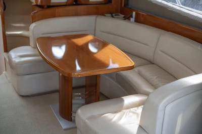 Luxurious interior of 2005 Princess 42 Flybridge Motor Yacht with elegant seating and wooden table.