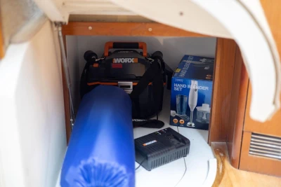 Storage compartment in 2005 Princess 42 Flybridge Yacht with tools and kitchen appliances.