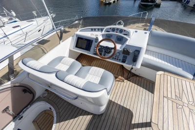 Flybridge helm of 2005 Princess 42 Motor Yacht with wooden steering wheel and navigation equipment.