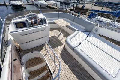 Flybridge view of 2005 Princess 42 Motor Yacht with seating and helm controls.