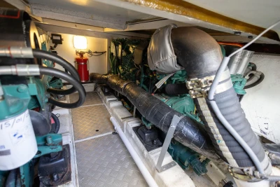 Engine room of 2005 Princess 42 Flybridge Motor Yacht, featuring mechanical components and fire extinguisher.