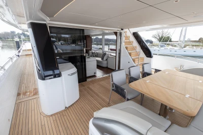 Luxurious 2023 Princess X80 yacht deck with elegant seating and dining area.