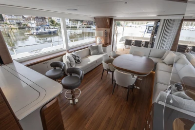 Luxurious interior of 2023 Princess X80 yacht with elegant seating and large windows.