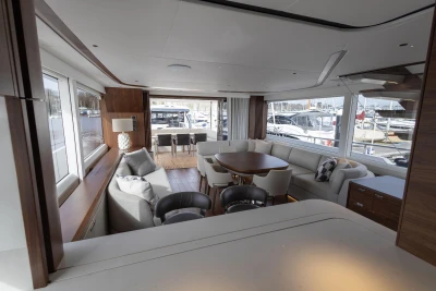 Luxurious interior of 2023 Princess X80 yacht with elegant seating and large windows.
