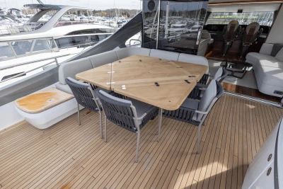 Luxurious 2023 Princess X80 yacht deck with elegant seating and wooden table.