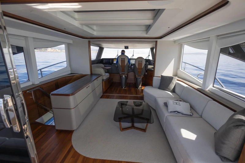 Luxurious interior of 2024 Princess X80 yacht with modern seating and panoramic windows.