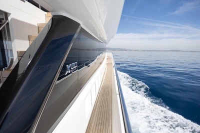 2024 Princess X80 yacht cruising on calm blue waters under a clear sky.