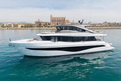 2024 Princess X80 yacht cruising near historic waterfront architecture.