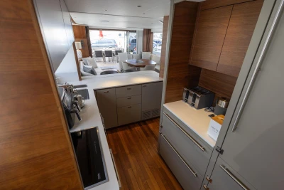 Luxurious 2024 Princess X80 yacht interior with modern kitchen and elegant dining area.