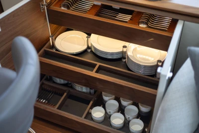 Elegant dining storage in 2024 Princess X80 yacht, featuring organized plates and cutlery.