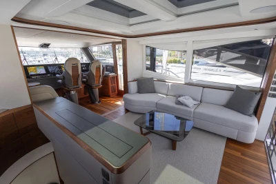 Luxurious interior of 2024 Princess X80 yacht with modern seating and navigation area.