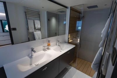 Luxurious bathroom in 2024 Princess X80 yacht with dual sinks and modern shower.
