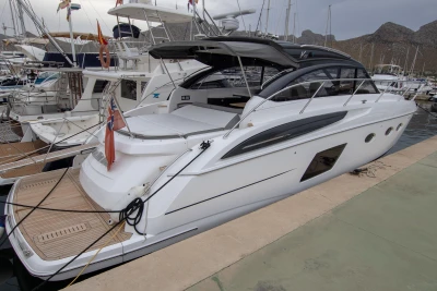 2017 Princess V48 Open yacht docked at marina, sleek design, luxury vessel.
