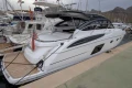 2017 Princess V48 Open yacht docked at marina, sleek design, luxury vessel.