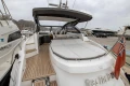 2017 Princess V48 Open yacht with spacious deck and elegant design in marina setting.