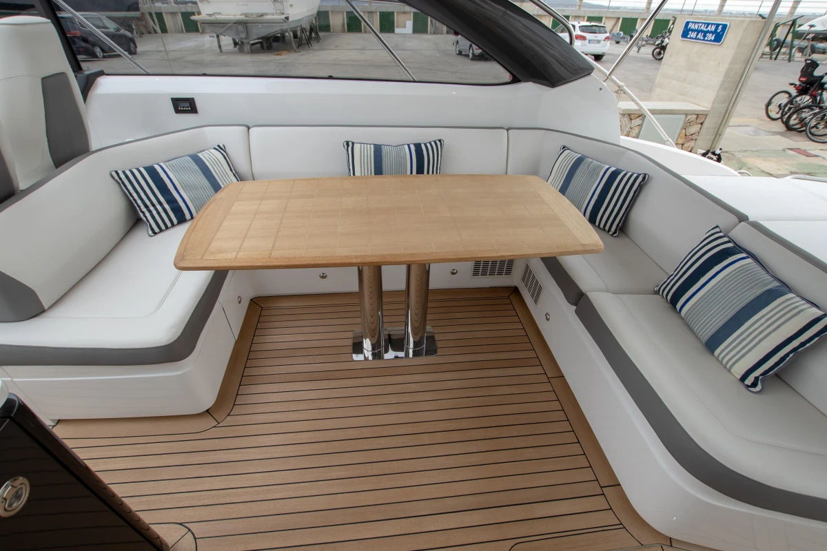 Luxurious 2017 Princess V48 Open yacht interior with elegant seating and wooden table.