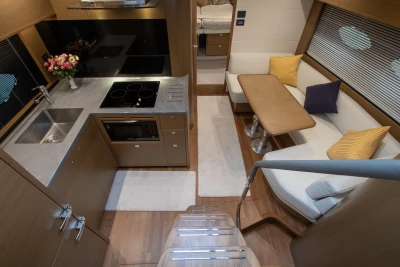 Luxurious interior of 2017 Princess V48 Open yacht with modern kitchen and cozy seating area.