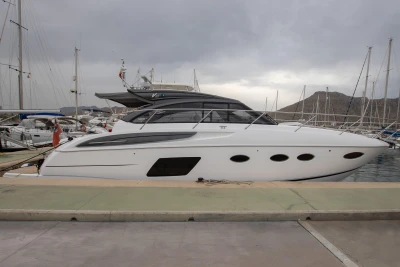 2017 Princess V48 Open yacht docked at a marina under cloudy skies.