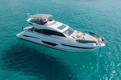 Luxurious 2018 Princess S65 yacht cruising on clear turquoise waters.