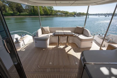 Luxurious 2026 Princess Y72 yacht deck with elegant seating and scenic water view.